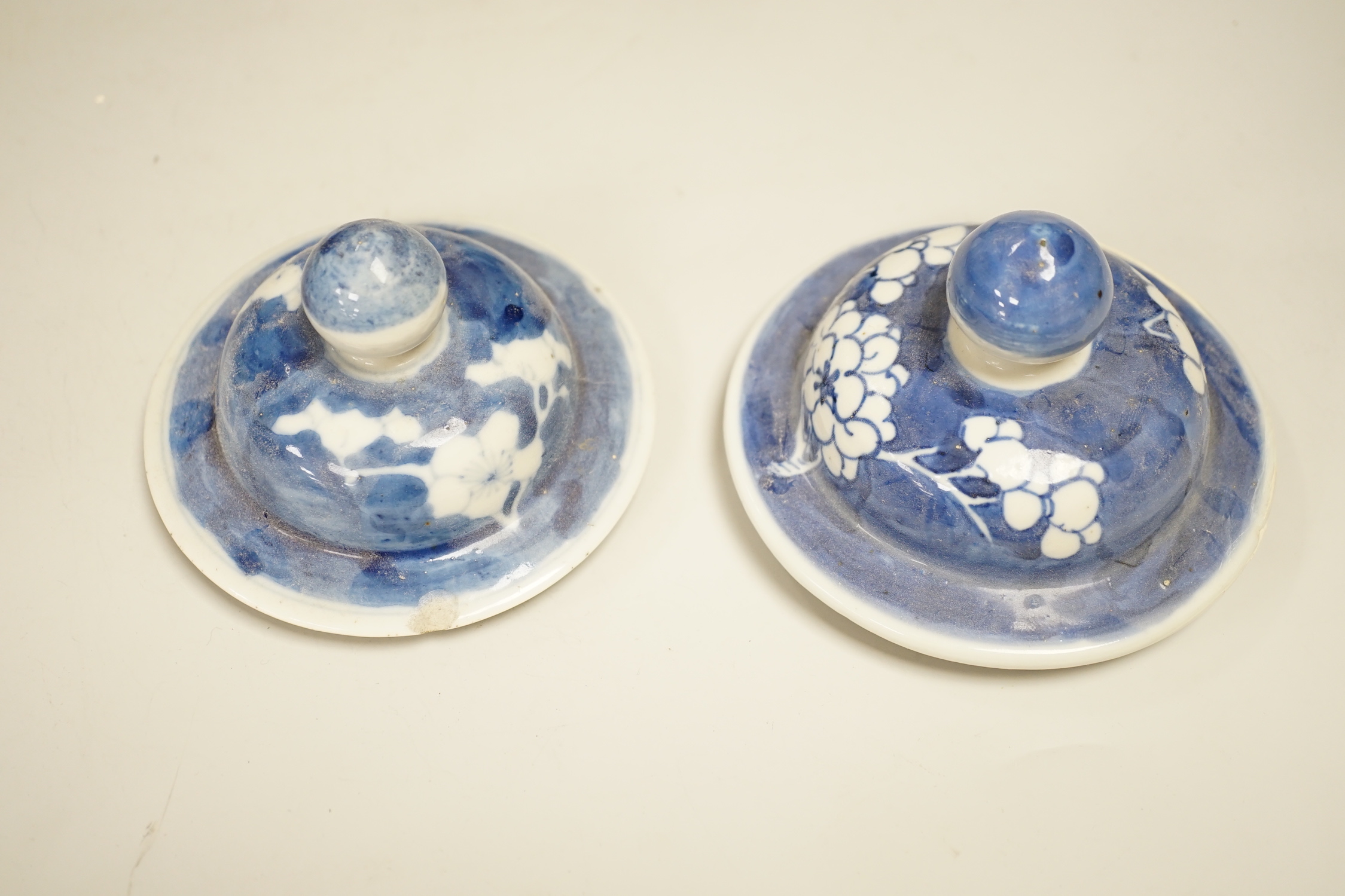 A pair of Chinese blue and white prunus pattern vases and covers, 21cm high